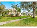 Exterior view of home showing lush landscaping and well-manicured lawn at 2207 Climbing Ivy Dr, Tampa, FL 33618