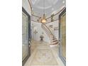 Grand foyer with curved staircase, mosaic tile, and soaring ceilings create an impressive entrance at 2207 Climbing Ivy Dr, Tampa, FL 33618