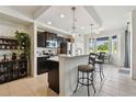 Bright kitchen with dark cabinetry, barstool seating, and stainless appliances at 1003 Fairwaycove Ln # 103, Bradenton, FL 34212