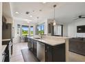 Well-lit kitchen with views and stainless appliances at 1003 Fairwaycove Ln # 103, Bradenton, FL 34212