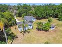 Quaint single-story home surrounded by lush greenery and mature trees at 101 N Taylor Rd, Seffner, FL 33584