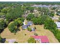 Aerial view of a property with mature trees, green lawn, and a quaint home at 101 N Taylor Rd, Seffner, FL 33584