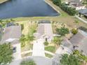 Overhead view of a single Gathering home with a screened pool and lake at 10911 Rockledge View Dr, Riverview, FL 33579