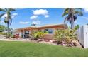 Well-manicured lawn surrounds this charming home with mature landscaping, adding to its curb appeal and inviting atmosphere at 11535 64Th Ter, Seminole, FL 33772