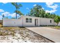 Charming single-story home with white siding, a well-maintained front yard, and a concrete driveway at 1235 Stockton Dr, Clearwater, FL 33755