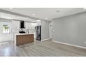 Modern open kitchen with white cabinets, stainless steel appliances, and a stylish center island at 1235 Stockton Dr, Clearwater, FL 33755
