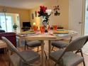 Dining room featuring a set table with seating for four and an open-concept view into the living room at 1301 S Hercules Ave # 19, Clearwater, FL 33764