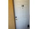 Unit 19's white front door provides private entrance to the condo at 1301 S Hercules Ave # 19, Clearwater, FL 33764