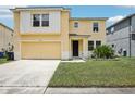 Charming two-story home featuring a well-maintained lawn and inviting entryway at 13506 Copper Belly Ct, Riverview, FL 33569