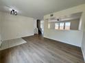 Bright and open living room with wood-look floors, neutral colors, and an airy feel at 13506 Copper Belly Ct, Riverview, FL 33569
