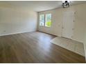 Spacious living room with wood-look flooring, neutral paint, and a bright airy feel at 13506 Copper Belly Ct, Riverview, FL 33569