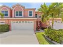 Charming two-story townhome featuring a two-car garage and well-maintained landscaping at 14506 Alejo Ct, Seminole, FL 33776