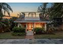 Inviting two-story home with a cozy front porch, stone pillars, and lush greenery at 146 8Th Ne Ave, St Petersburg, FL 33701