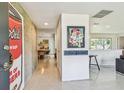 Modern entryway with unique art, sleek flooring, and an open view into the living spaces at 1714 Cypress Ave, Belleair, FL 33756