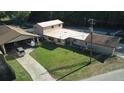 Aerial view of property showing the house, detached garages, driveways, and landscaping at 18121 Geraci Rd, Lutz, FL 33548