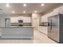 Well-lit kitchen boasts stainless steel appliances, white cabinets, granite counters and pantry at 190 Rain Berry Ave, Ruskin, FL 33570