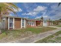 Charming single-story home with well-maintained landscaping and a welcoming entrance at 2105 Sugarbush Dr, Holiday, FL 34690