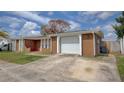Exterior of the home showing the garage and driveway at 2105 Sugarbush Dr, Holiday, FL 34690