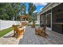 Outdoor patio area with chairs, swing, and screened-in porch offering a relaxing outdoor space at 2387 Bartolo Dr, Land O Lakes, FL 34639