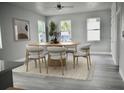 Bright dining area featuring a stylish wood table, contemporary chairs, and natural light at 2504 E 28Th Ave, Tampa, FL 33605