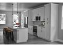 Modern kitchen with sleek white cabinets, stainless steel appliances, and a spacious center island at 2504 E 28Th Ave, Tampa, FL 33605