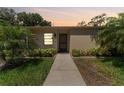 Charming single-story home with a well-maintained lawn and lush tropical landscaping at 2640 Woodgate Ln # F6, Sarasota, FL 34231