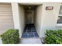 Charming front entrance featuring a stone tile entryway and lovely exterior landscaping at 2826 Rampart Cir, Clearwater, FL 33761