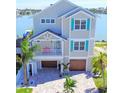 Charming coastal home with a two-car garage, lush landscaping, and inviting curb appeal near the water at 305 Harbor Dr, Indian Rocks Beach, FL 33785