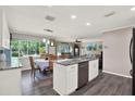 Bright kitchen featuring an island, granite countertops, stainless steel appliances, and an adjacent dining area and living room at 3060 55Th N Ave, St Petersburg, FL 33714