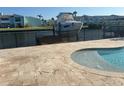 Waterfront pool featuring boat lift and waterfront views, set in a coastal neighborhood at 324 6Th Ave, Indian Rocks Beach, FL 33785