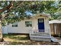 Charming single-story home with white siding, a blue front door, and a cozy porch at 3970 56Th Ave N, St Petersburg, FL 33714