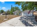 Single-story home featuring an attached garage and well-maintained lawn, set in a tranquil residential neighborhood at 4017 Moog Rd, Holiday, FL 34691