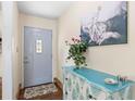 Cozy entryway with decorative cabinet and artwork, leading into the main living area at 4018 Highgate Dr, Valrico, FL 33594