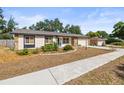 Single-story home with stone accents and a well-maintained lawn on a sunny day at 4018 Highgate Dr, Valrico, FL 33594