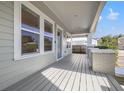 Inviting front porch with a wood-plank floor and stylish support pillars, perfect for relaxing outdoors at 410 W Chelsea St, Tampa, FL 33603