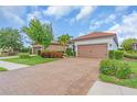 Exterior shot showcasing a well-maintained home with a tile roof and a brick driveway at 4610 Alexandria Ct, Palmetto, FL 34221