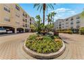 Beautifully landscaped courtyard with a central fountain and colorful flowerbeds within a condo community at 501 Knights Run Ave # 1335, Tampa, FL 33602