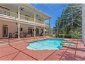 Inviting backyard pool and patio area featuring a covered veranda and outdoor bar at 5017 Muir Way, Lithia, FL 33547