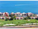 Beautiful aerial view of a condo community and golf course near the water with a boat speeding by at 5736 La Puerta Del Sol S Blvd # 254, St Petersburg, FL 33715