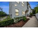 Modern townhouse with neutral exterior, landscaped garden bed, and accessible ramp at 6904 S Macdill Ave # 1, Tampa, FL 33611