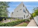 Modern building exterior with clean lines, black fencing, and landscaping at 6904 S Macdill Ave # 1, Tampa, FL 33611