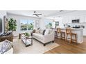 Bright, open-concept living room with kitchen and dining area, featuring modern furnishings and beautiful water views at 7023 Montauk Point Xing, Bradenton, FL 34212