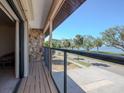 Balcony overlooking street, trees, and water at 7085 Sunset S Dr # A, St Petersburg, FL 33707