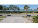 Street view of water across the street and palm trees at 7085 Sunset S Dr # A, St Petersburg, FL 33707