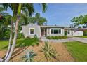 Charming single-story home featuring a well-manicured lawn and inviting front entrance at 716 75Th N St, St Petersburg, FL 33710