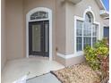 Inviting front entrance featuring a decorative glass door and elegant sidelights at 9644 Jasmine Brook Cir, Land O Lakes, FL 34638