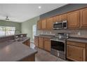 Functional kitchen featuring stainless steel appliances, wooden cabinets, and laminate countertops at 9644 Jasmine Brook Cir, Land O Lakes, FL 34638