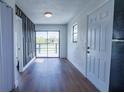 Bright living room features hardwood floors, a sliding glass door, and view of the community pond and the deck at 9706 N 22Nd St, Tampa, FL 33612