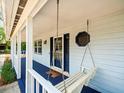 Inviting front porch with a charming porch swing and a tranquil spot for relaxation at 10206 N Hyaleah Rd, Tampa, FL 33617