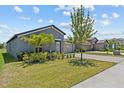 Well-maintained lawn and landscaping in front of a single-story home with a two-car garage at 10433 Alder Green Dr, Riverview, FL 33578